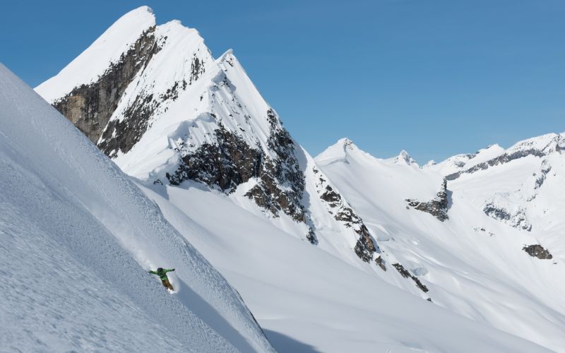 heli-skiing-canada-skier-on-steep-slope-min