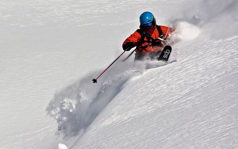 heli-skiing-canada-skier-in-very-deep-powder-min