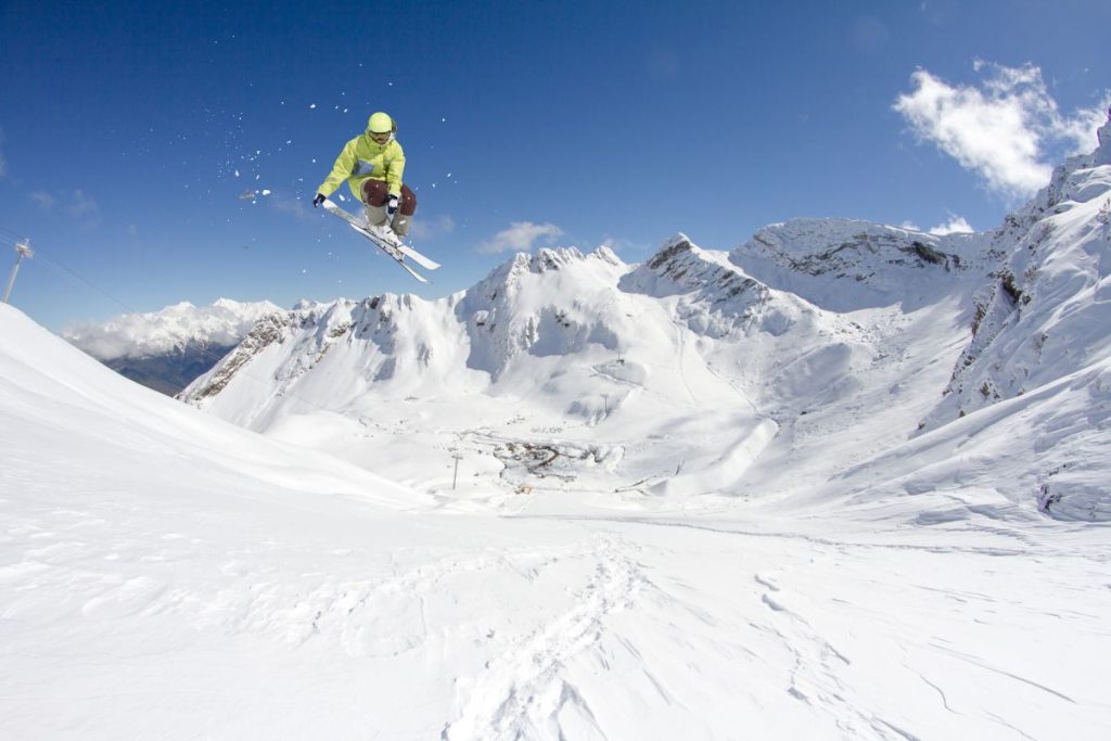 heli-skiing-canada-flying-skier-on-mountains-min