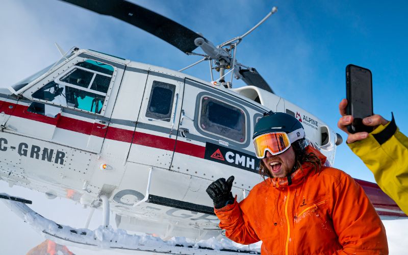 heli-skiing-canada-skier-in-front-of-helicopter-min