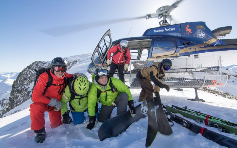 heli-ski-turkey-trip-skiers-next-to-chopper-min